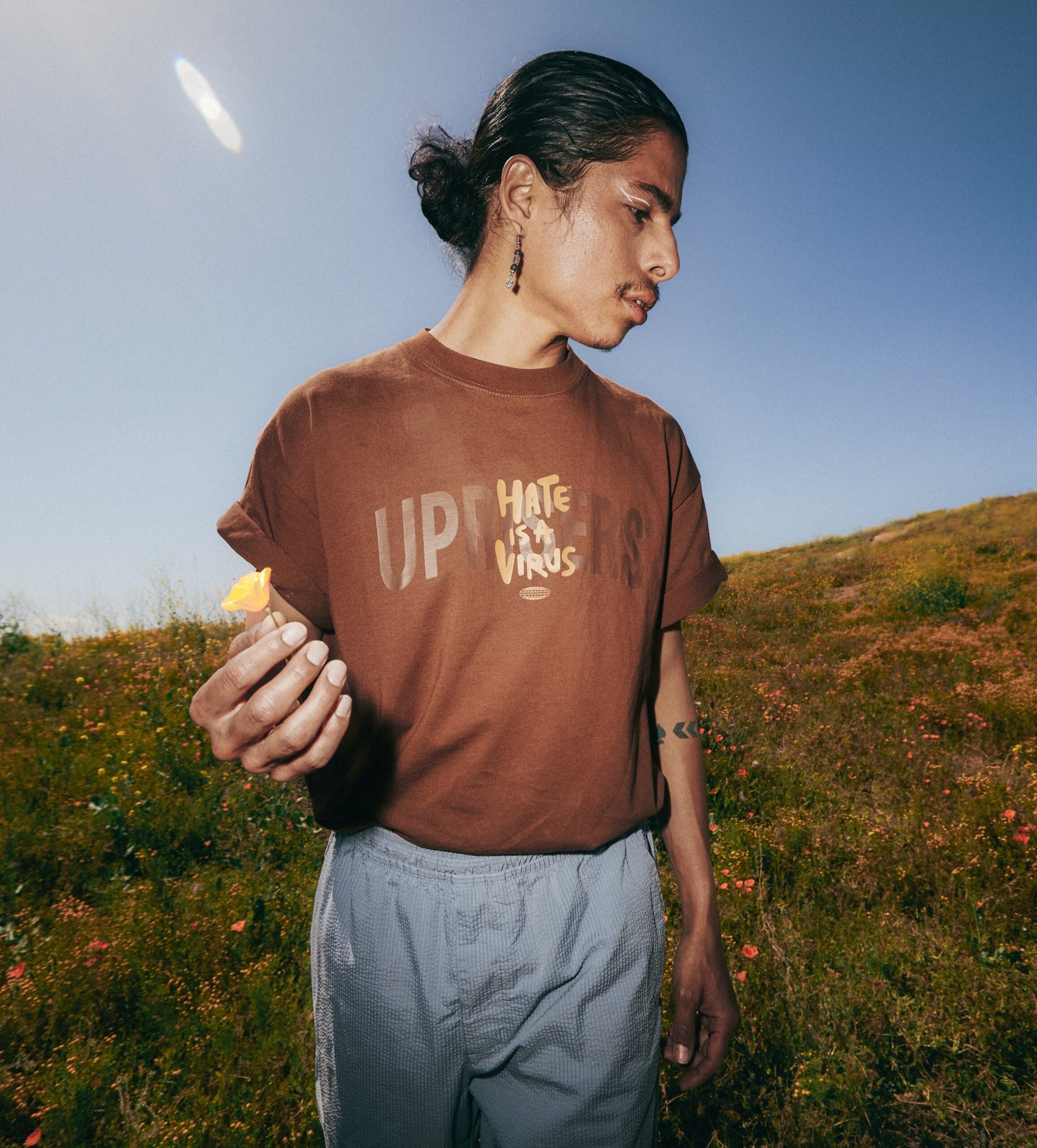 Model wearing a t-shirt in a field.