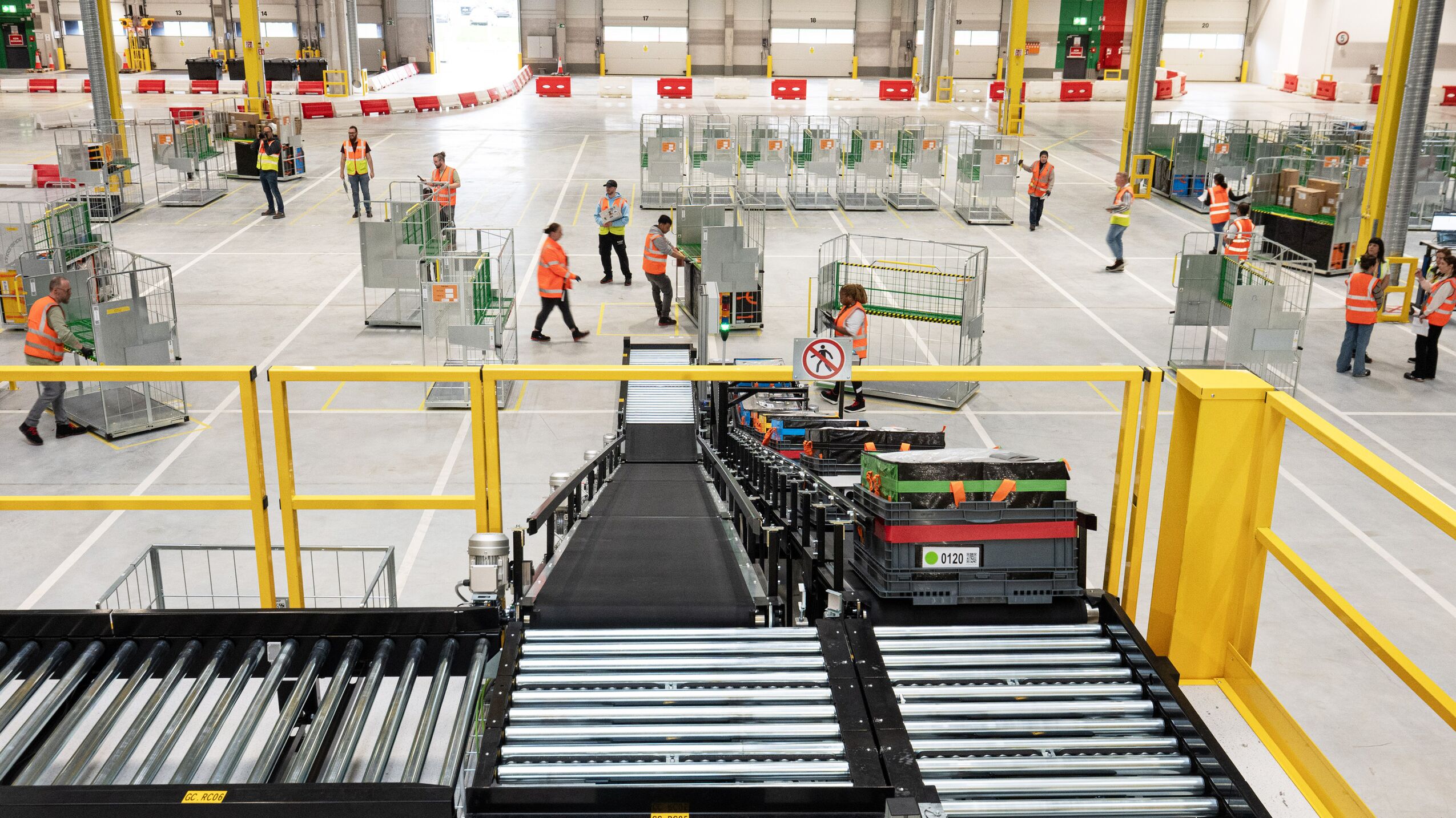 Amazon fulfillment center showing staff and automated sorting equipment