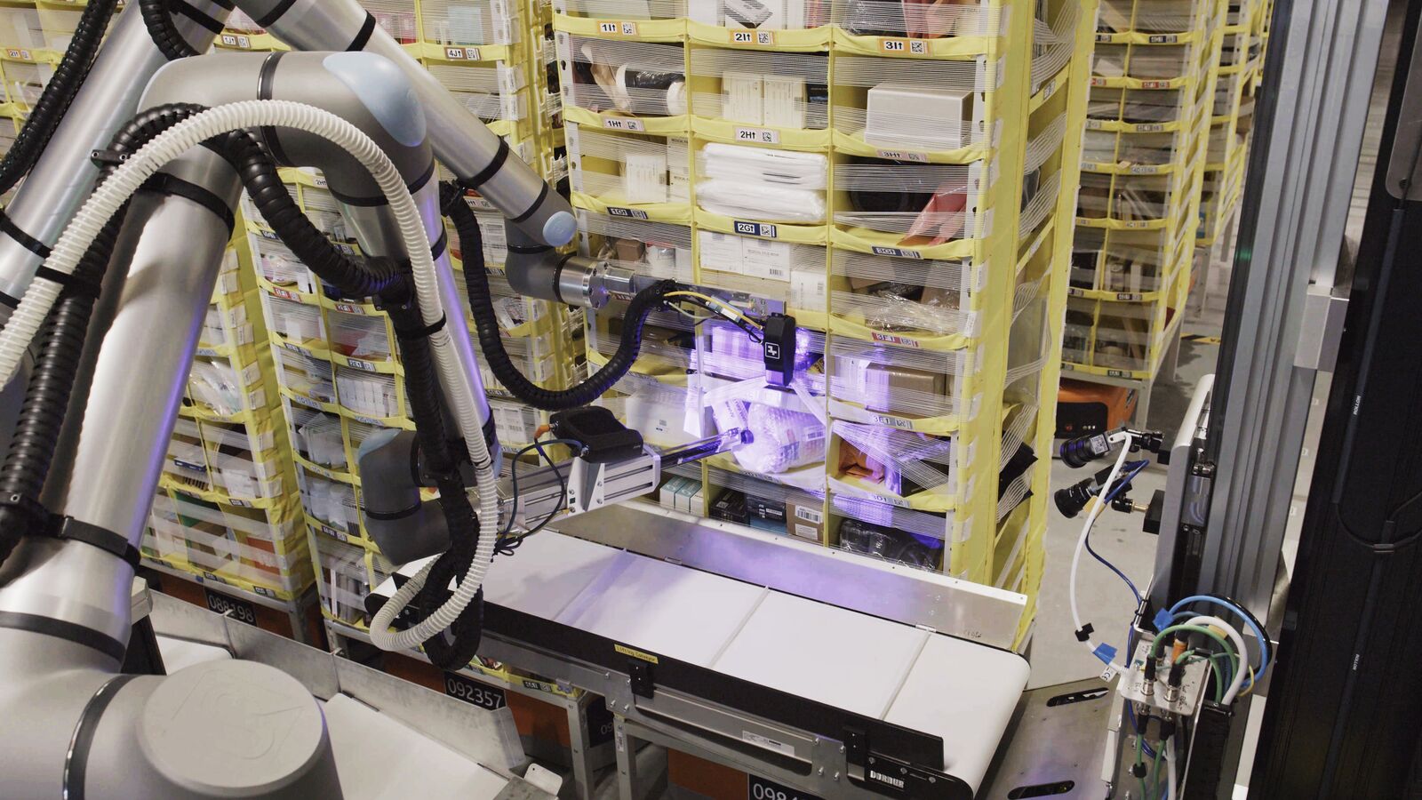 Amazon's Vulcan robot using a suction cup to pick an item from the lower part of a storage pod