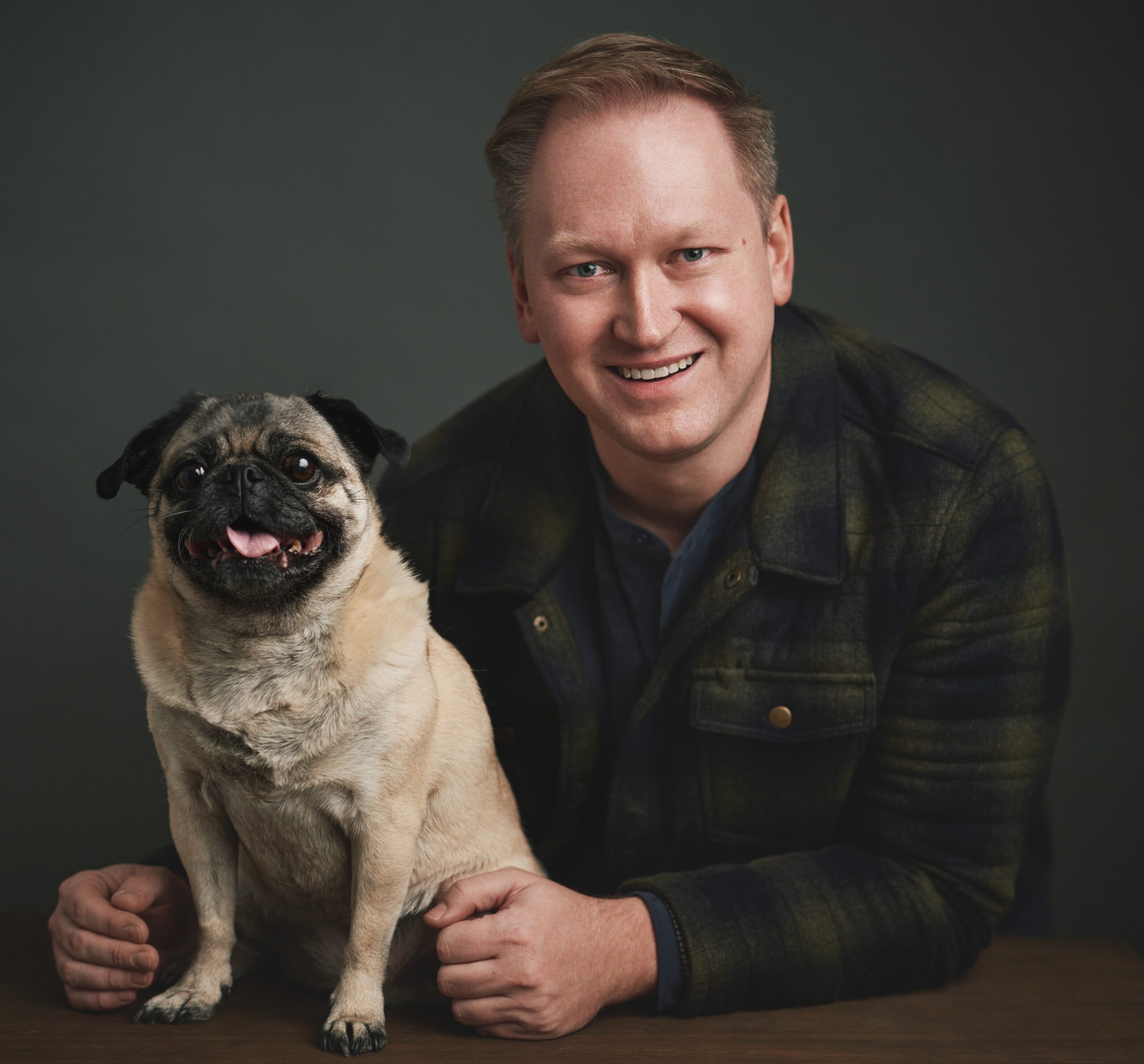 William Smolen poses smiling with his pug.